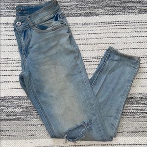 Mid rise skinny jeans with distressed knees